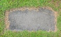 Stone texture background covered with green grass around. Concrete pattern with copy space at center Royalty Free Stock Photo