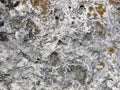 Stone texture. Detailed surface of the old light stone with red lichens. Royalty Free Stock Photo