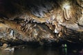 Stone texture inside cave and rowing woman row a boat with tourist at Trang An Grottoes in Ninh Binh, Vietnam