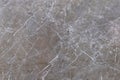 Grey-brown polished granite surface with various cracks Royalty Free Stock Photo