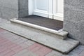 Stone threshold with foot mat at the entrance door made of white wood. Royalty Free Stock Photo