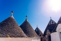 Stone tiles cover the roofs of the trulli in Alberobello, an Italian city to visit on a trip to Italy