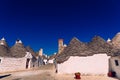 Stone tiles cover the roofs of the trulli in Alberobello, an Italian city to visit on a trip to Italy