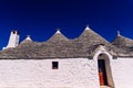 Stone tiles cover the roofs of the trulli in Alberobello, an Italian city to visit on a trip to Italy