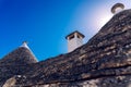 Stone tiles cover the roofs of the trulli in Alberobello, an Italian city to visit on a trip to Italy