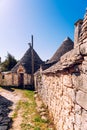 Stone tiles cover the roofs of the trulli in Alberobello, an Italian city to visit on a trip to Italy