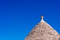 Stone tiles cover the roofs of the trulli in Alberobello, an Italian city to visit on a trip to Italy