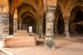 A stone tomb in an arcaded hall at the ruins of the ancient Adina Masjid mosque in the