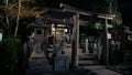 Stone torii gate and little shinto altar at Yasaka Jinja shrine in night Royalty Free Stock Photo