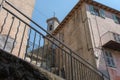 Stone tower with clock and bell, up view to the bell tower, ancient church with a watch, a small village in the mountains. Royalty Free Stock Photo