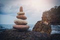 Stone tower on the rock near pebble beach. Royalty Free Stock Photo