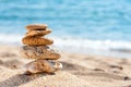 Stone tower in sand against sea. Royalty Free Stock Photo