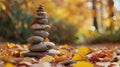 A stone tower, a testament to balance, rises amid the colors of fall in a serene setting. Ai Generated Royalty Free Stock Photo