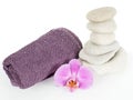 Stone tower with towel and orchid flower Royalty Free Stock Photo