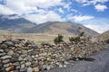 Stone traditional protection from the winds against the backdrop of the Himalayan mountains takes place in the upper reaches of