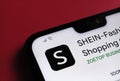 Stone / UK - July 14 2020: SHEIN app fashion shopping online platform seen on the corner of smartphone which is placed on the red