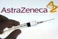 AstraZeneca vaccine also known as Oxford COVID vaccine. Hand holding a syringe and AstraZeneca logo on the blurred background. Co Royalty Free Stock Photo