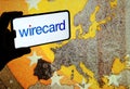 Wirecard logo on smartphone and euro banknote large image on the blurred background screen. Royalty Free Stock Photo