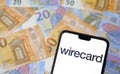 Stone /United Kingdom - June 22 2020: Wirecard logo on smartphone and euro banknotes on the blurred background. Wirecard AG is a Royalty Free Stock Photo