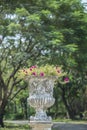 Stone vase in the old classical style with flowers in the park, Royalty Free Stock Photo