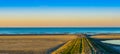 Stone walking path of rocks leading to the sea, beautiful beach at sunset in Blankenberge, Belgium Royalty Free Stock Photo