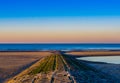 Stone walking or rocks leading into the ocean, beautiful and colorful sky at sunset, Blankenberge beach, Belgium Royalty Free Stock Photo