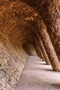 Stone walkway with a colonnade in the famous Antoni Gaudi Park G Royalty Free Stock Photo