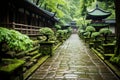 a stone walkway lined with mossy trees in a japanese garden