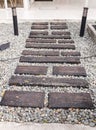 Stone walkway winding in garden. Stone block pathway and gray gravel in the park. landscape path in the garden. Royalty Free Stock Photo