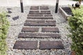 Stone walkway winding in garden. Stone block pathway and gray gravel in the park. landscape path in the garden. Royalty Free Stock Photo