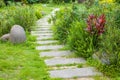 The stone walkway winding its way through a tranquil summer garden Royalty Free Stock Photo