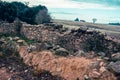 Stone wall in autumn field photo. Farmland in the countryside, simple scene, rural fields landscape Royalty Free Stock Photo