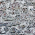 Stone wall background closeup, vertical plastered grunge red grey beige stonewall limestone pattern, old aged weathered gray lime Royalty Free Stock Photo