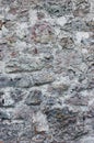 Stone wall background closeup, vertical plastered grunge red grey beige stonewall limestone pattern, old aged weathered gray lime Royalty Free Stock Photo