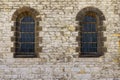 Stone wall of the church with two windows with arches Royalty Free Stock Photo