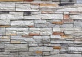 Stone wall cladding made of gray rock mixed with red and black stripes