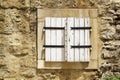 stone wall with closed wooden shutters window in Budva Old Town Royalty Free Stock Photo