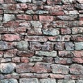 Stone wall closeup, stonewall pattern background, old aged weathered red and grey grunge limestone dolomite calcium hard slate Royalty Free Stock Photo