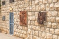 Stone wall decorated with products of local artists in the famous artists village Ein Hod near Haifa in northern Israel