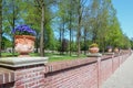 Stone wall decorated with violets filled earthenware pots