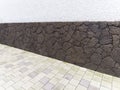 Stone wall from different angles, with white cement and gray brick floor