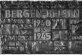 The stone wall at the entrance to Bergen Belsen Concentration Camp with the dates when it was in use