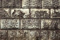 Stone wall with flower relief on each stone brick