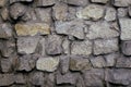 Stone wall gray cobblestone and boulders with coarse cement bonds Royalty Free Stock Photo