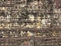Stone wall with images of people carved on it temple complex Angkor Wat..