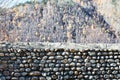 Stone wall. Laying of stones on a background autumn forest. Autumn.