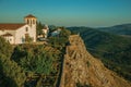 Stone wall with lush garden and old church on sundown Royalty Free Stock Photo