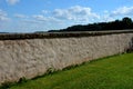 stone wall, in the meadow with stone lining of the top of the canopy. Royalty Free Stock Photo