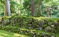 Stone wall with moss, and trees, in summer. Eiheiji, Japan Royalty Free Stock Photo