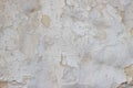 Stone wall with a multilayered old tumbling whitewash texture Royalty Free Stock Photo